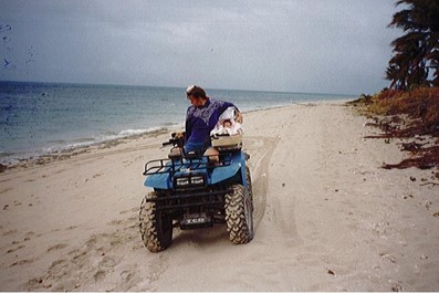 The Principal and his vehicle on Poruma beach. 