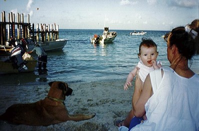 An image of Poruma Island landing with Kerri, her child and a dog. 