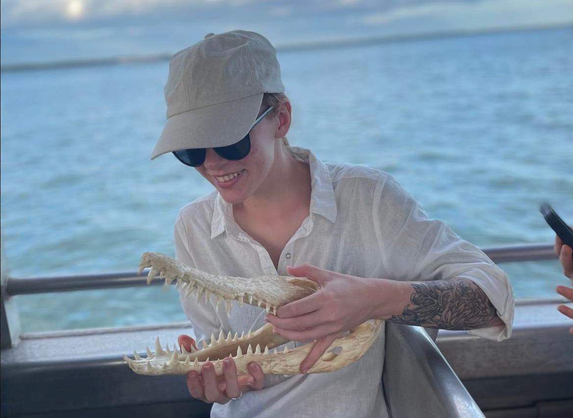 Paige holding the skeleton of a crocodile’s head.